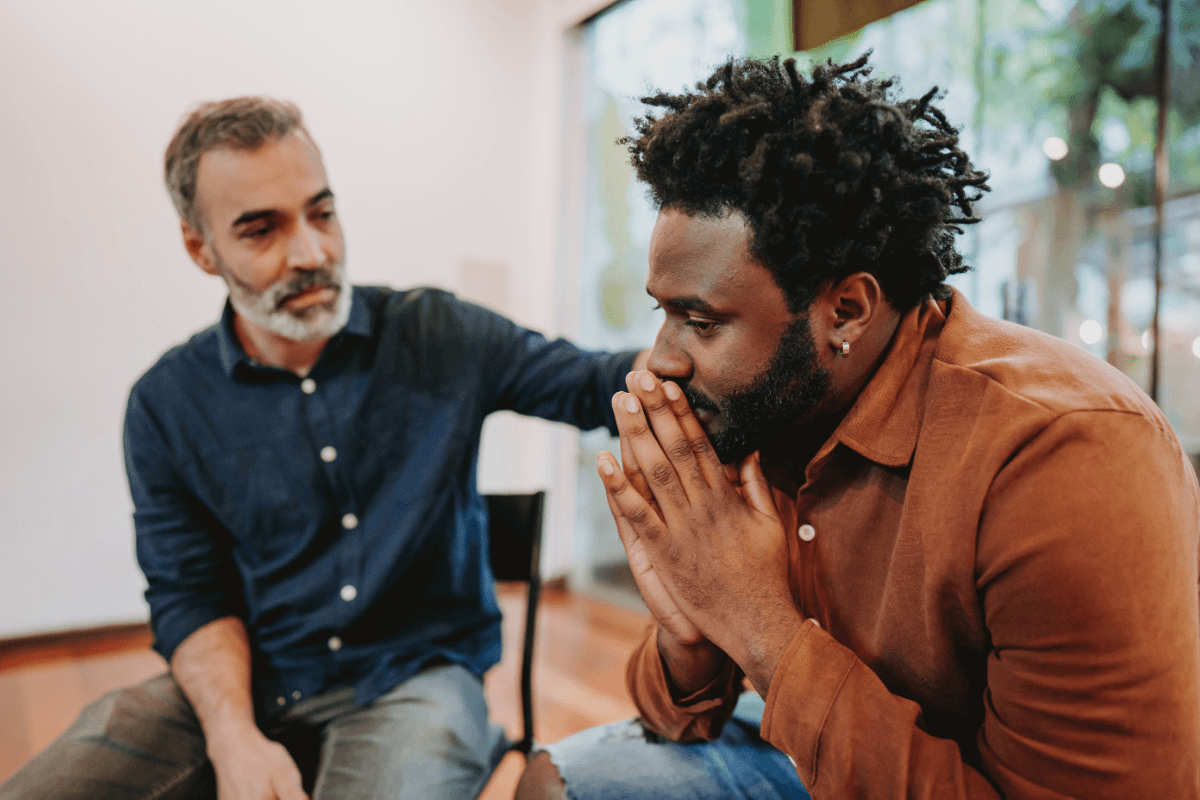 Therapist sitting with a client who looks distressed