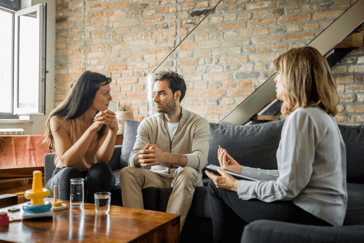 Couple talking with a counselor during a therapy session