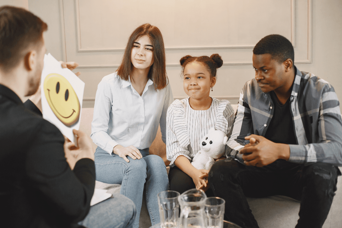 Family sitting with a therapist during a counseling session