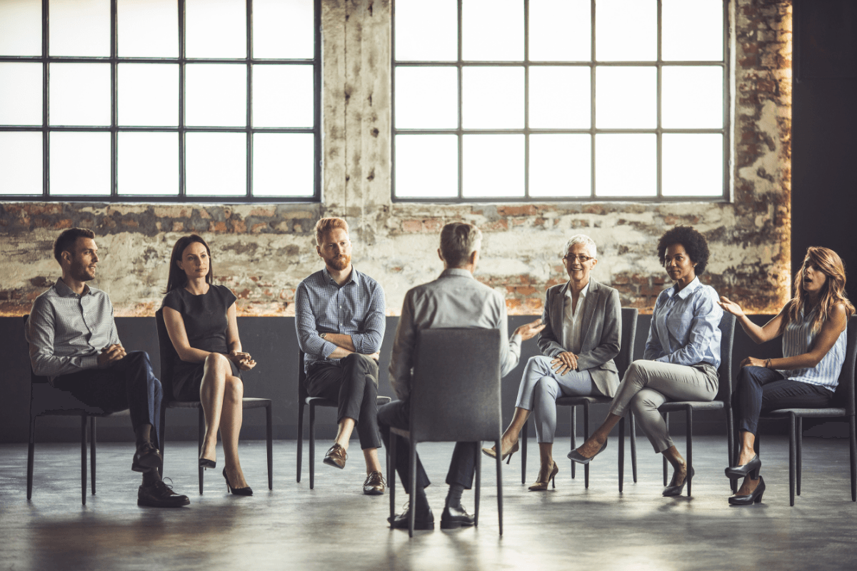 People seated in a circle during a group therapy session